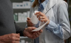 senior man consulting female pharmacist medication 1